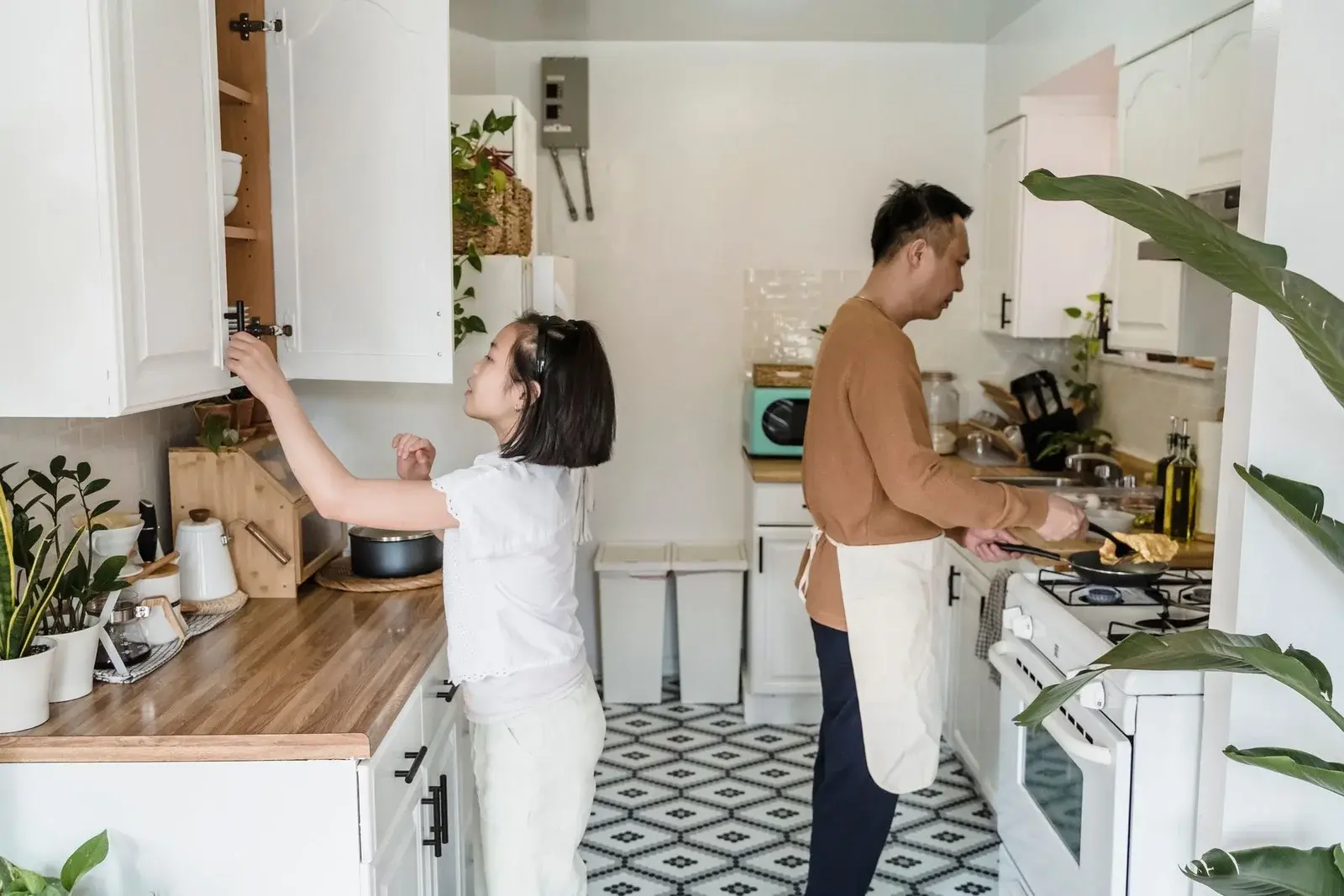 Two adults preparing a meal together in a bright kitchen
